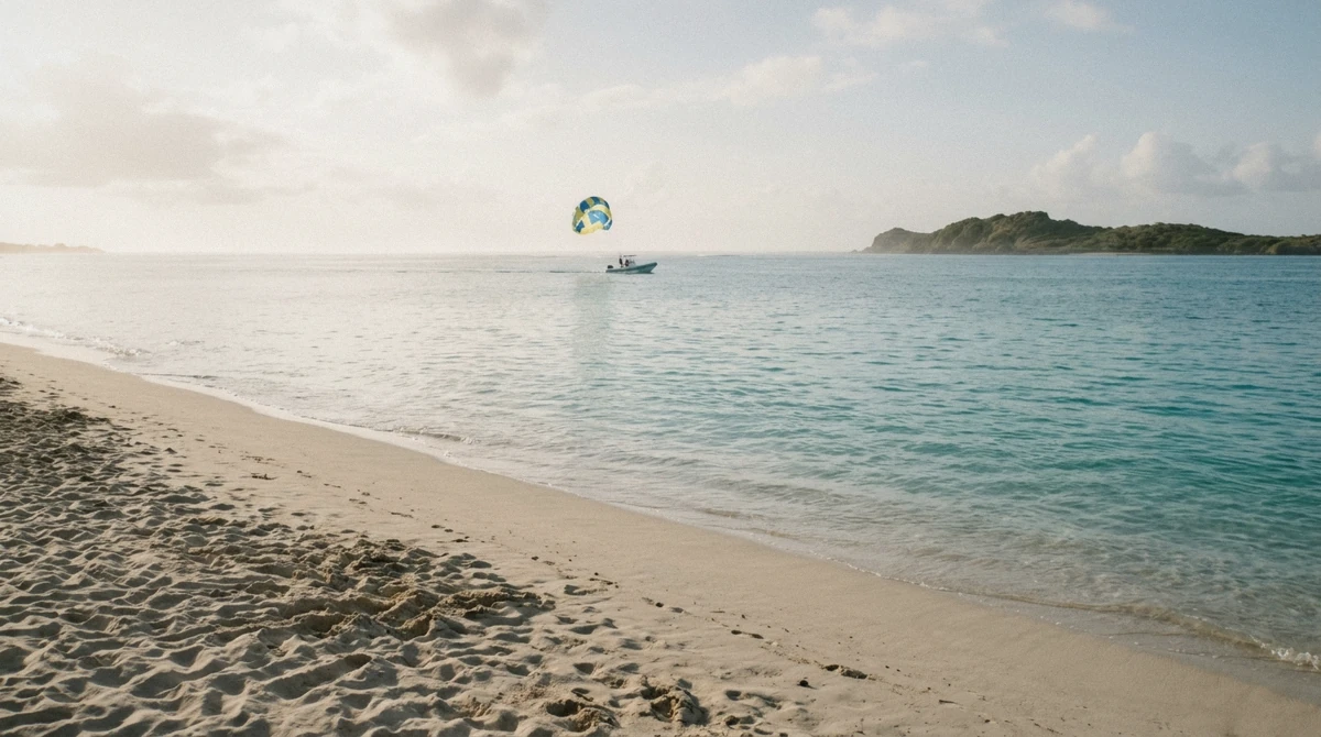 Glassy turquoise water at sunrise over Orient Bay, the best time of day for parasailing in St Maarten